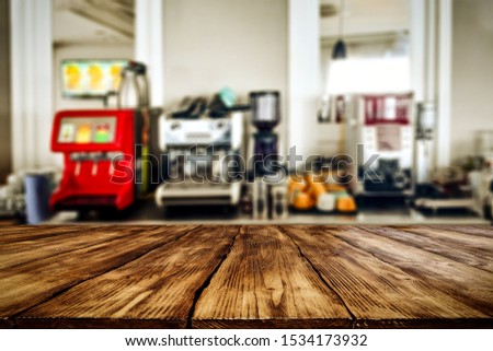 Table background of free space for your decoration and blurred background of kitchen 