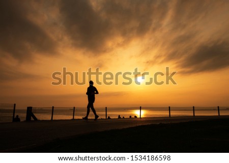 Running man silhouette in sunset time. Sport and active life concept - Image