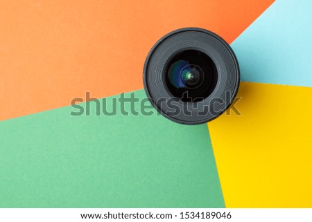 one modern photo lens on a colored background, digital color rendering concept, copy space