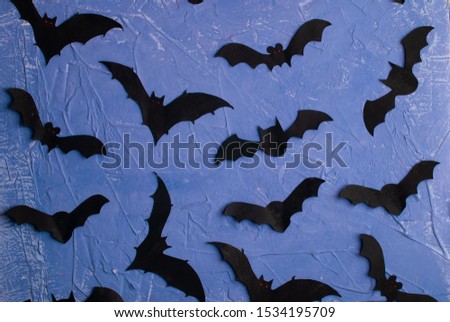 Halloween background. Paper cut bats flying. Top view with copy space.