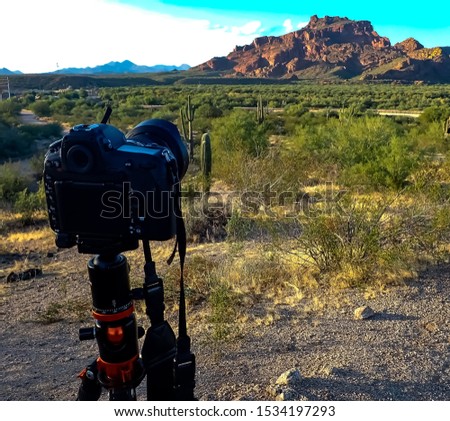 A tripod and camera set up to take a sunset shot of Red Mountain located in Mesa Arizona.