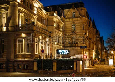 Beautiful illuminated Hotel building on French street at dusk