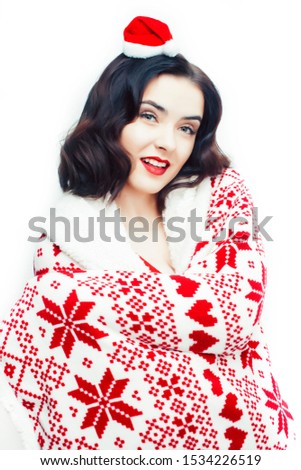 young pretty happy smiling blond woman on christmas in santas red hat and decorated blanket isolated on white background, holiday people