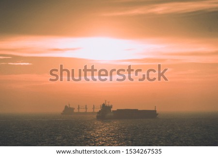 abstract photo of a ship transporter during fog and sunset