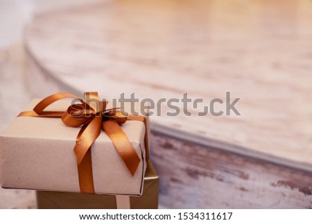 Christmas composition with craft gifts. Xmas or new year gold color presents on light background with empty copy space for text. holiday and celebration concept for postcard or invitation. 