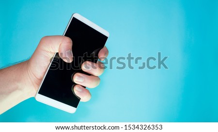 person squeezing cell phone in hand