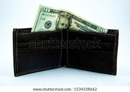 Still life picture of a wallet with a twenty dollar bill. Economy, finance, money related picture.