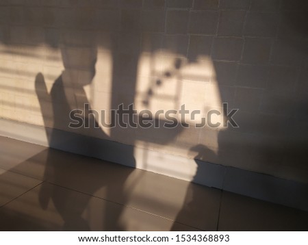 A child sitting on a chair in transparent shadow mode