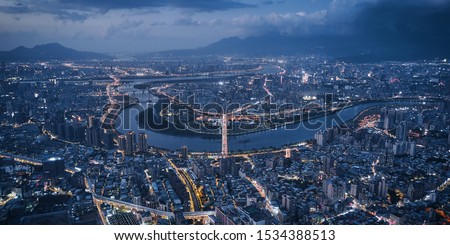 Aerial view of Taipei city - Asia business concept image, panoramic modern cityscape building bird’s eye view use the drone at night, shot in Taipei, Taiwan.