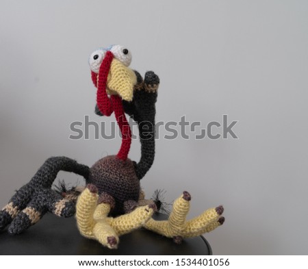 This is a crocheted turkey getting ready for Thanksgiving.