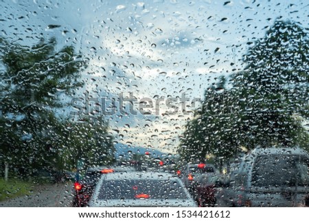 selective focus photo of water droplets on car windscreen, Traveling in a rainy day with traffic jam