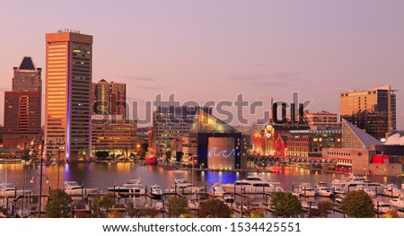 Colorful Baltimore skyline over the Inner Harbor at dusk