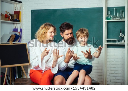 Pupil learning letters and numbers - mathematics concept. Education. Boy from elementary school. Young happy family schooling math together