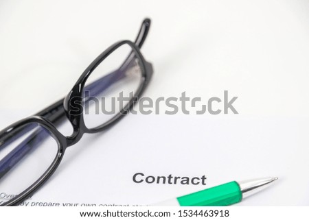 Sign on contract document with fountain pen and glasses on white background