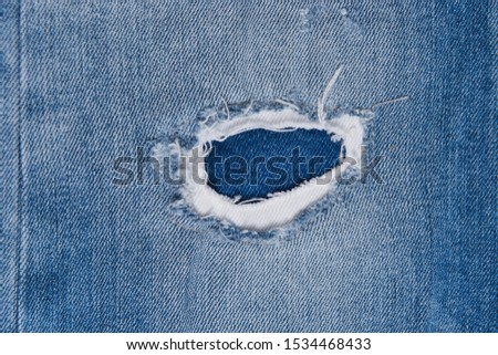 Denim Hole on jeans texture or denim jeans background
