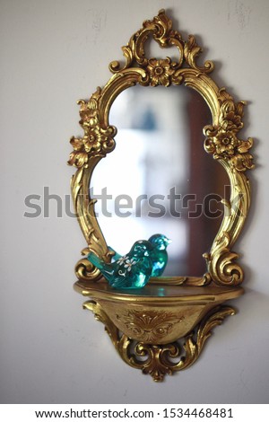 Gold wall mirror with glass bird