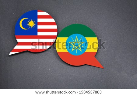 Malaysia and Ethiopia flags with two speech bubbles on dark gray background