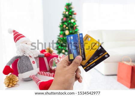 Christmas online shopping-Hand of female holding credit card for buys presents, prepare to xmas eve.
