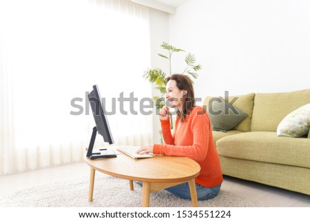 Young woman using a PC at home