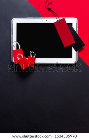 Black Friday shopping retail flat lay. Shopping bags, tablet for text and online shopping, car on a red-black background. Time for discounts and sales