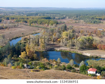 View from the top of Mount Kremyanets to the Izyum town, Ukraine / Autumn landscape: mountain, river, forest and houses