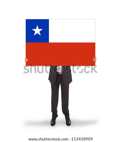 Businessman holding a big card, flag of Chile, isolated on white