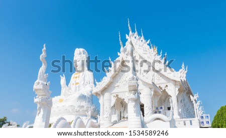Beautiful Big White Guan Yin Statue and White Dragon at Wat Huay Pla Kang Buddhist Temple. Landmark of Chiang Rai. Located in Thailand. Picture for Chiang Rai Travel Concept.