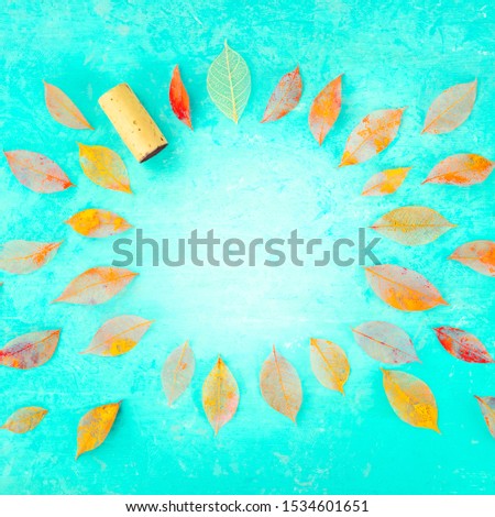 Autumn wine square background with autumn leaves on a blue texture, a design template for a winetasting invitation or a menu, with copy space