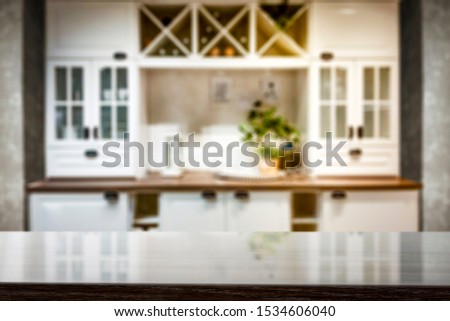 Table top with a blurred kitchen background and some kitchen accessories. Empty space for decoration and advertising products.