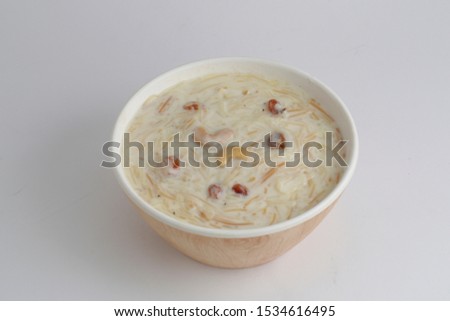 payasam -vermicelli or semiya isolated image of a sweet dish which is famous in india mainly south  india which is arranged in a bowl and garnished with dry fruits  with white background