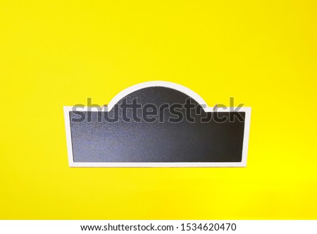 Blackboard labels, chalkboard labels, information boards or price tags on yellow table with copyspace

