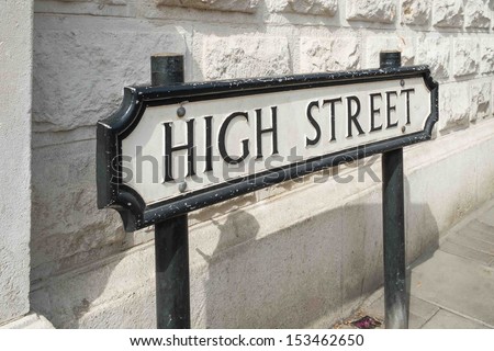A High Street road sign in front of a white wall Royalty-Free Stock Photo #153462650