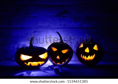 Halloween pumpkin head jack lantern in dark background.