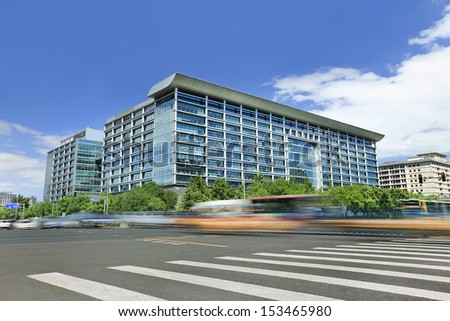 Modern office building with traffic in motion blur Royalty-Free Stock Photo #153465980