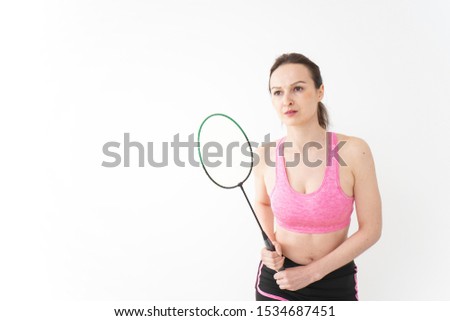 Young woman doing badminton wearing sportswear