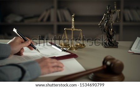 
A lawyer working at a desk in a courtroom