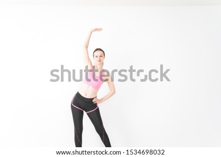 Young woman wearing sportswear stretching