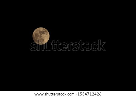 Full moon in the black sky at night