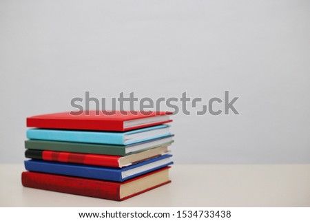 A bunch of red and blue books on a white background.Photo on the subject of books and reading.