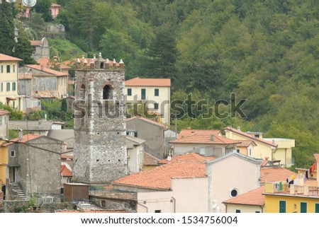 Colonnata, Carrara, Italy. About october 2019.  Overview of the village of Colonnata, where the famous lard is produced. The walls of the houses in stone and white Carrara marble. Woods background.