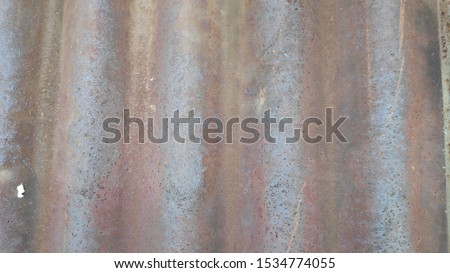 the background of the corrugated zinc board building, the photo blurred and out of focus