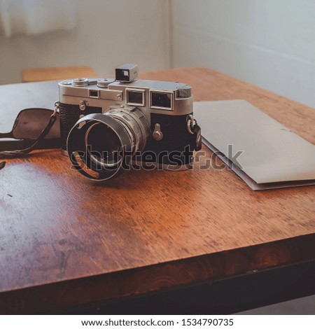 Pictures of old cameras placed on the table, retro style.