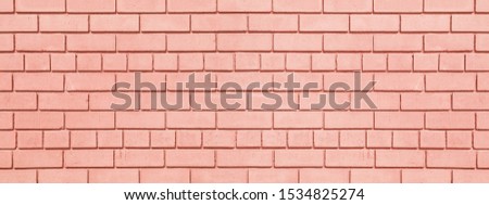 Coral painted brickwork wide background. Brick block widescreen texture. Peach color wall panorama