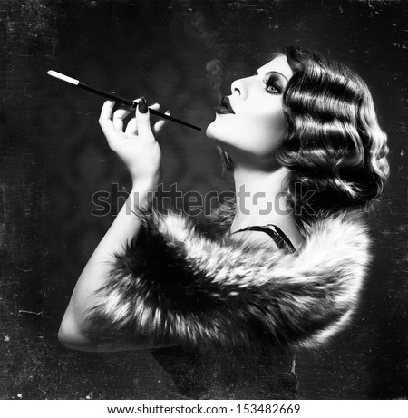 Retro Woman Portrait. Beautiful Woman with Mouthpiece. Cigarette. Smoking Lady. Vintage Styled Black and White Photo. Old Fashioned Makeup and Finger Wave Hairstyle. 20's or 30's style. 