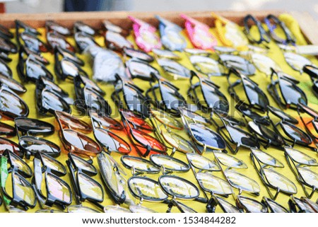 sunglasses of multi colored and design for sale on footpath