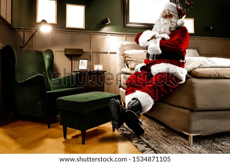 Red old Santa Claus in home and free space for your text. 