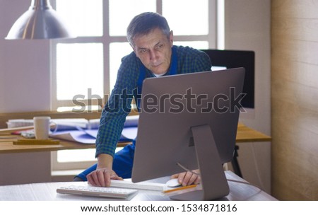 Engineer carpenter working on laptop and sketching project