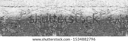 Light gray wide rough concrete wall texture. Weathered old cement surface long large background