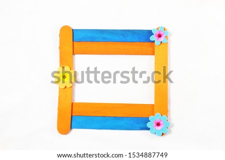 wooden popsicle stick frame isolated with copy space as background