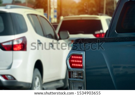Luxury of pickup car stop on the asphalt junction by traffic light control in across. Traveling in the provinces during the bright period. Open light brake.